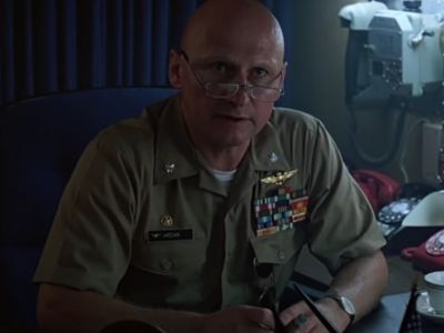 James Tolkan is on his uniform sitting on his desk.